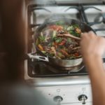 person cooking on black pan